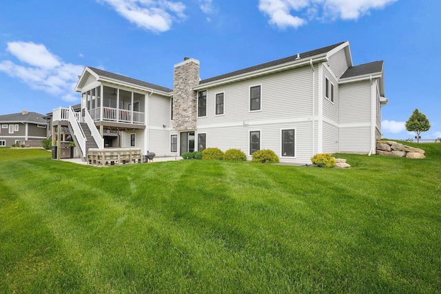 6249 Fountainhead Cir, Deforest, WI 53532 - rear view of house featuring a sunroom, a chimney, a lawn, and stairway