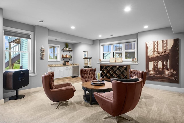 6249 Fountainhead Cir, Deforest, WI 53532 - living area with wet bar, light colored carpet, recessed lighting, baseboards, and healthy amount of natural light