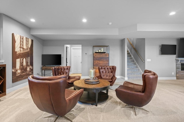 6249 Fountainhead Cir, Deforest, WI 53532 - living area featuring stairway, a fireplace, baseboards, recessed lighting, and light colored carpet