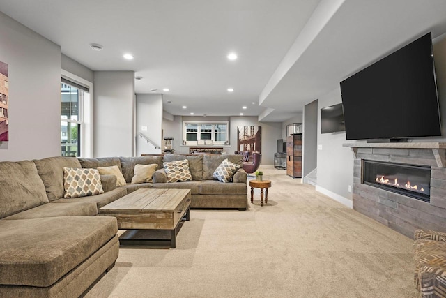 6249 Fountainhead Cir, Deforest, WI 53532 - living room with light colored carpet, a glass covered fireplace, recessed lighting, stairway, and baseboards