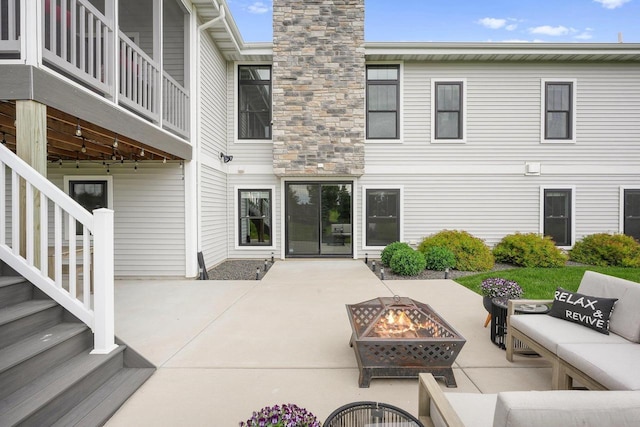6249 Fountainhead Cir, Deforest, WI 53532 - back of house with an outdoor living space with a fire pit, a chimney, and a patio