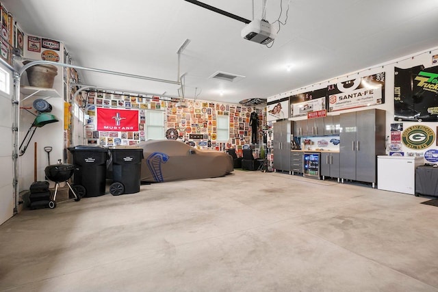 6249 Fountainhead Cir, Deforest, WI 53532 - garage featuring a garage door opener and a workshop area
