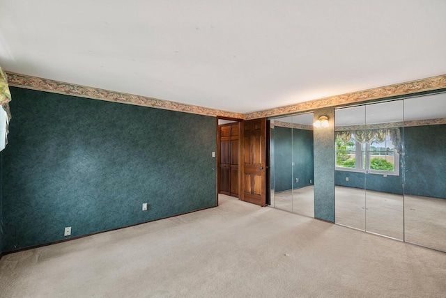 6262 W College Ave, Greendale, WI 53129 - unfurnished bedroom with multiple closets and carpet