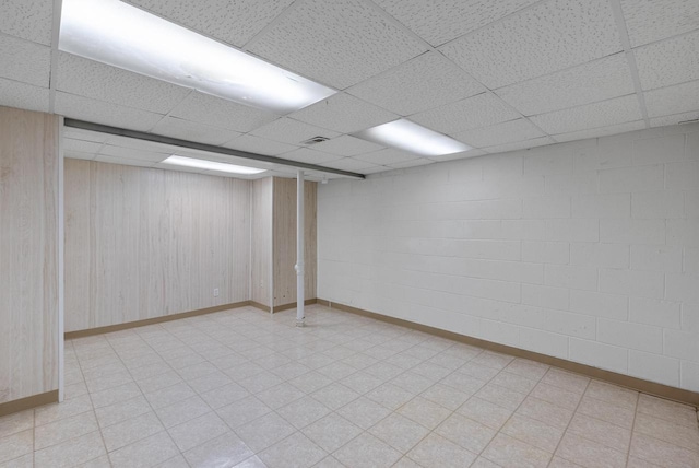6262 W College Ave, Greendale, WI 53129 - finished basement with a paneled ceiling, baseboards, wood walls, and light floors