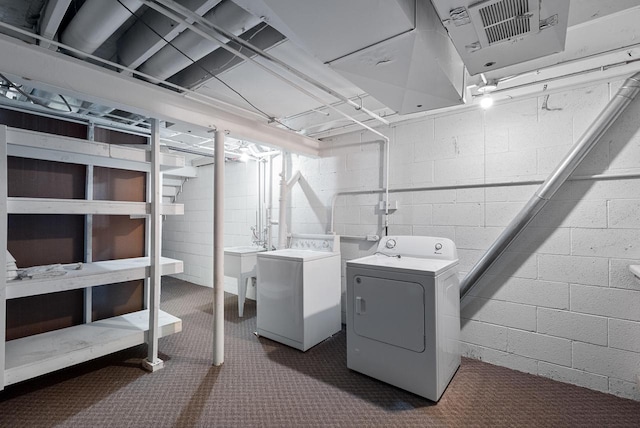 6262 W College Ave, Greendale, WI 53129 - washroom with washing machine and dryer, dark carpet, and concrete block wall