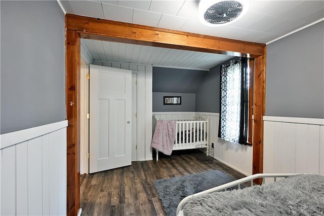 54675 Cudworth Ave, Grand View, WI 54839 - bedroom with wood finished floors, beam ceiling, and a wainscoted wall