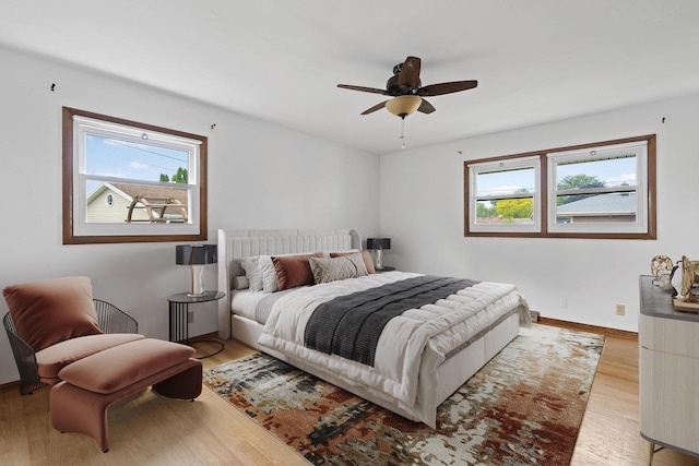 1615 Hickory St, South Milwaukee, WI 53172 - bedroom with multiple windows, light wood finished floors, and a ceiling fan