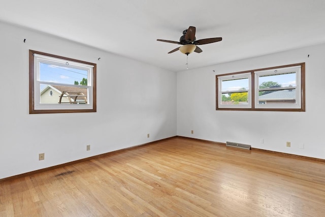 1615 Hickory St, South Milwaukee, WI 53172 - empty room with plenty of natural light, light wood finished floors, and a ceiling fan