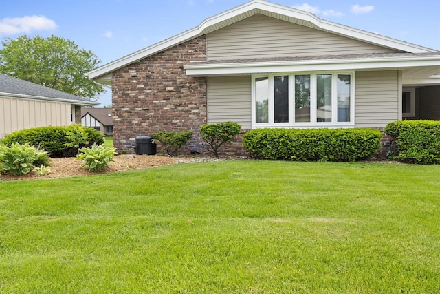 1615 Hickory St, South Milwaukee, WI 53172 - view of property exterior with a lawn, a shingled roof, and brick siding