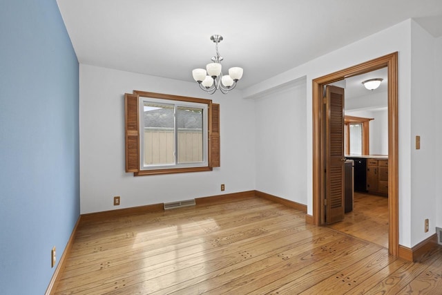 1615 Hickory St, South Milwaukee, WI 53172 - spare room with light wood-style floors and a chandelier