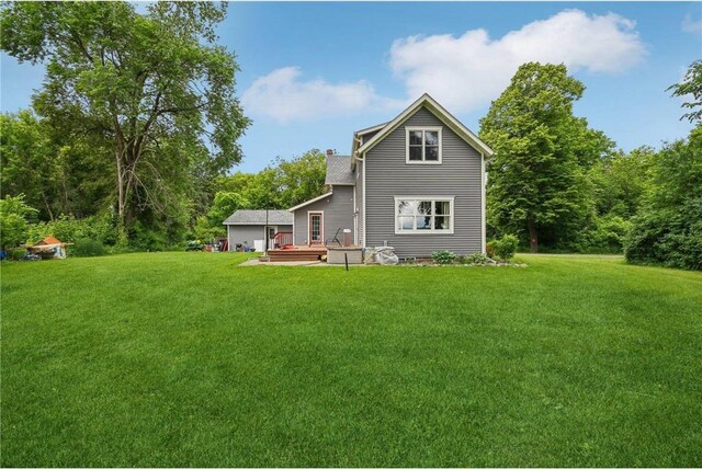 2256 40th Ave Unit X, Osceola, WI 54020 - rear view of property featuring a wooden deck, a lawn, and a chimney