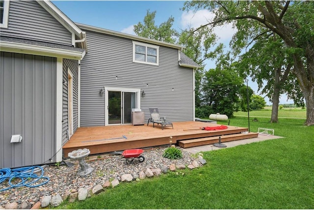 2256 40th Ave Unit X, Osceola, WI 54020 - rear view of property featuring board and batten siding, a lawn, and a deck