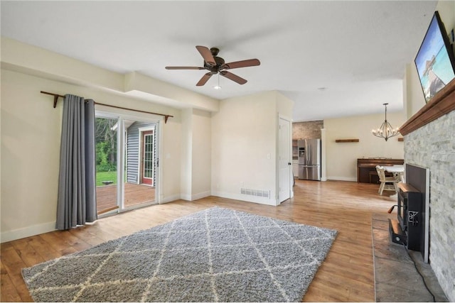 2256 40th Ave Unit X, Osceola, WI 54020 - unfurnished living room featuring ceiling fan, a chandelier, and wood finished floors