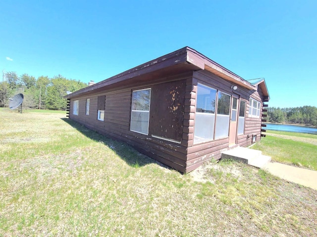 W5677 Alice Ln, New Lisbon, WI 53950 - view of home's exterior featuring a yard and log exterior