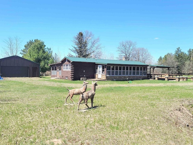 W5677 Alice Ln, New Lisbon, WI 53950 - rear view of property with a lawn, an outbuilding, and a detached garage