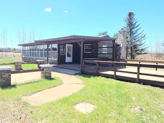 W5677 Alice Ln, New Lisbon, WI 53950 - view of front facade with a chimney and a front yard