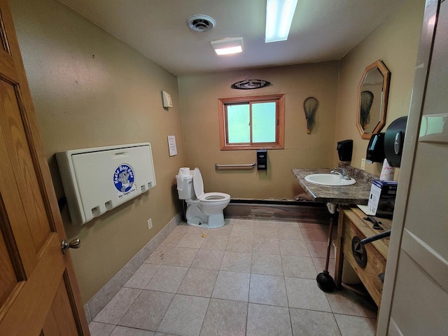 W2671 State Highway 64 E, White Lake, WI 54491 - bathroom with toilet, a sink, tile patterned flooring, and baseboards