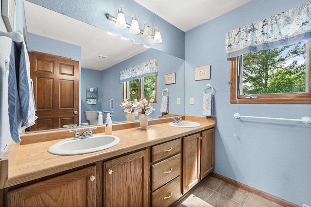 N7844 Lake Shore Ln, Sherwood, WI 54169 - bathroom with double vanity, tile patterned floors, and baseboards