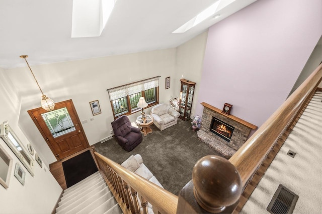 N7844 Lake Shore Ln, Sherwood, WI 54169 - carpeted living room with high vaulted ceiling, a skylight, and a fireplace