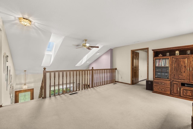 N7844 Lake Shore Ln, Sherwood, WI 54169 - interior space featuring a ceiling fan, a skylight, light carpet, vaulted ceiling, and baseboards
