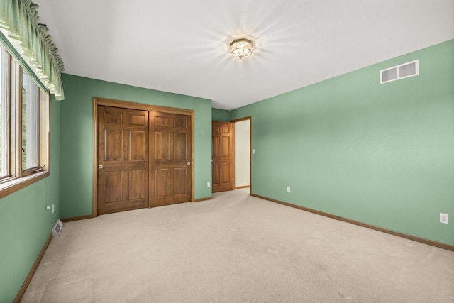 N7844 Lake Shore Ln, Sherwood, WI 54169 - unfurnished bedroom with baseboards and light colored carpet