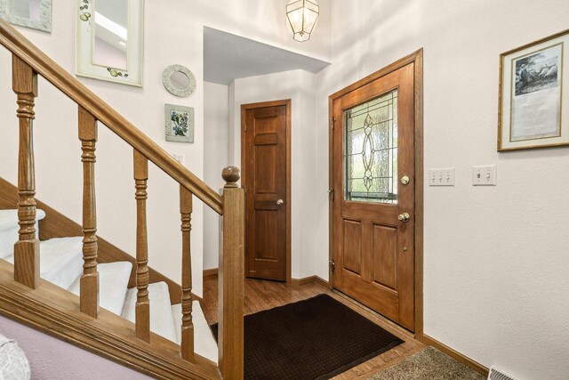 N7844 Lake Shore Ln, Sherwood, WI 54169 - entrance foyer featuring wood finished floors, baseboards, and stairs