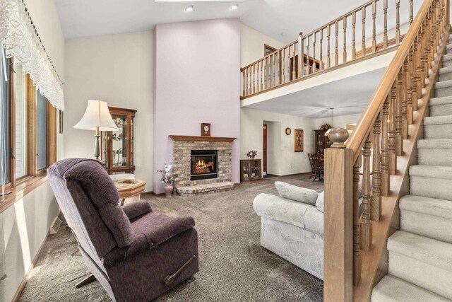 N7844 Lake Shore Ln, Sherwood, WI 54169 - carpeted living room with a high ceiling, a fireplace, stairway, and recessed lighting