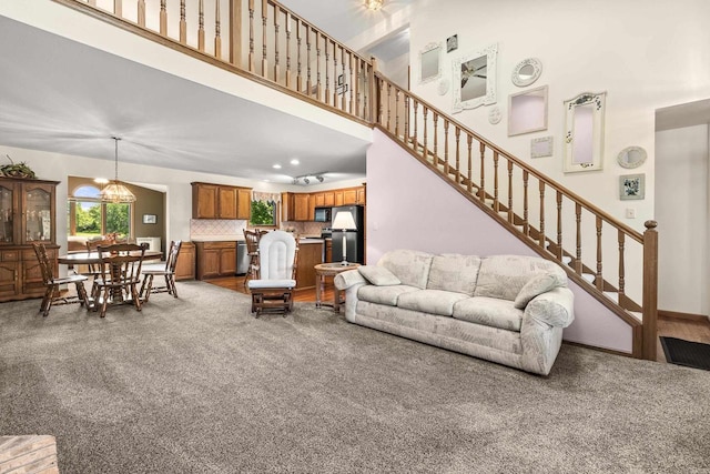 N7844 Lake Shore Ln, Sherwood, WI 54169 - carpeted living area with plenty of natural light, stairway, and a towering ceiling