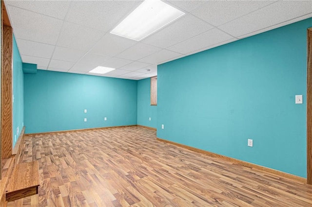 231 S Woodworth St, Elmwood, WI 54740 - unfurnished room with wood finished floors, a paneled ceiling, and baseboards