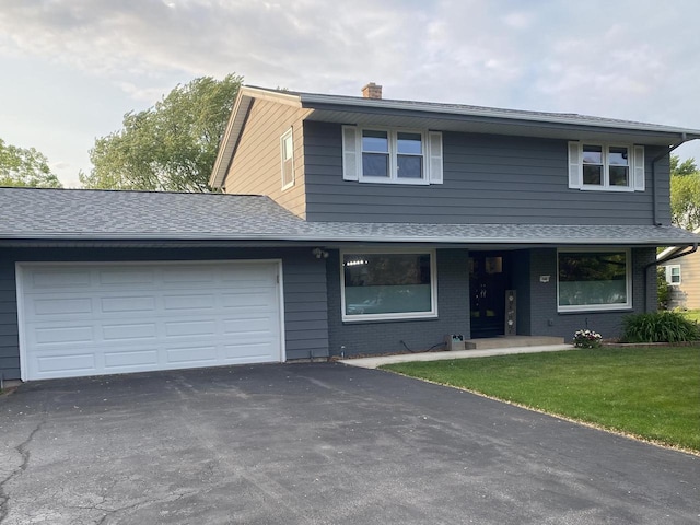 540 W Manor Cir, Bayside, WI 53217 - view of property featuring asphalt driveway, an attached garage, a chimney, a front lawn, and brick siding