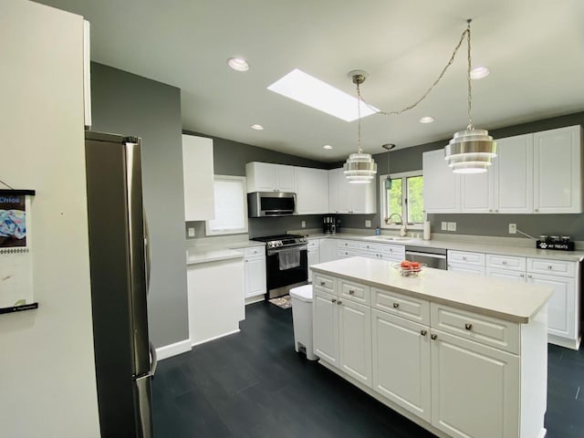 540 W Manor Cir, Bayside, WI 53217 - kitchen featuring stainless steel appliances, a center island, white cabinetry, light countertops, and recessed lighting