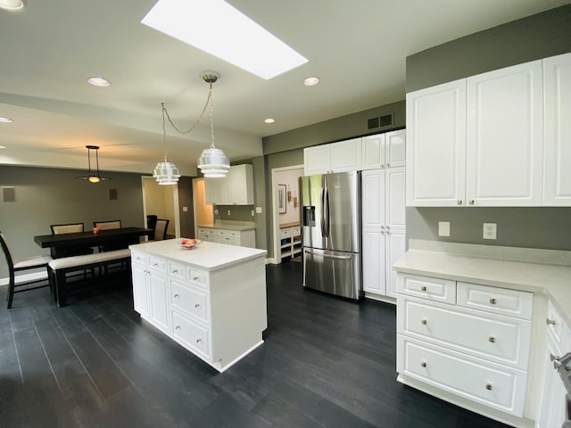 540 W Manor Cir, Bayside, WI 53217 - kitchen with stainless steel fridge with ice dispenser, a skylight, recessed lighting, white cabinets, and dark wood-style floors