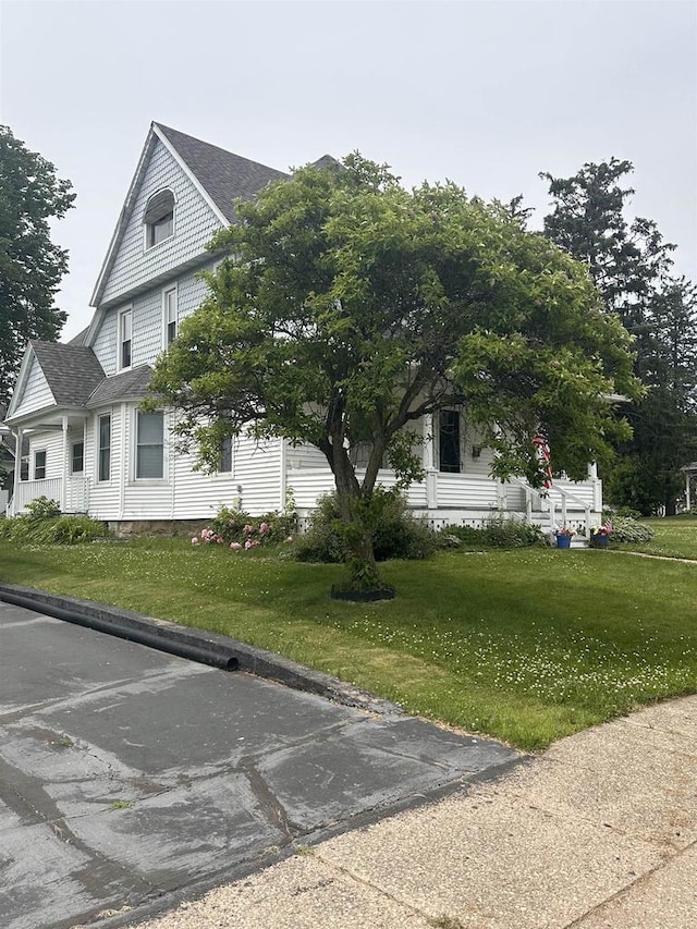 352 N Harrison St, Lancaster, WI 53813 - view of side of property with a yard and a shingled roof