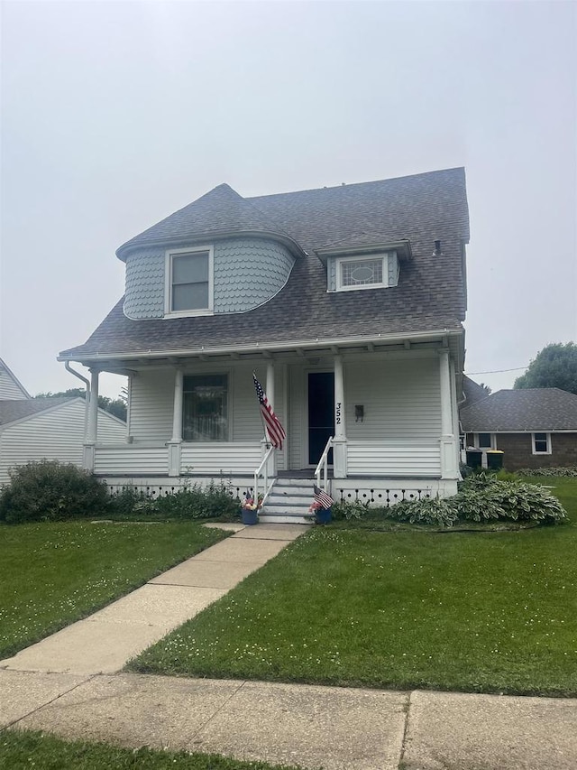 352 N Harrison St, Lancaster, WI 53813 - view of front facade featuring a porch, a front lawn, and roof with shingles