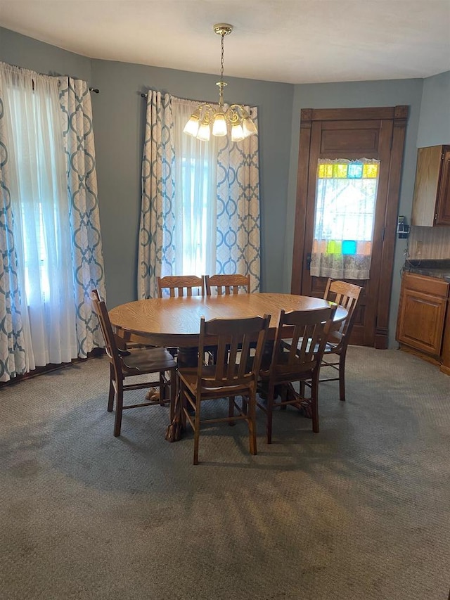 352 N Harrison St, Lancaster, WI 53813 - dining area featuring plenty of natural light, light carpet, and a chandelier