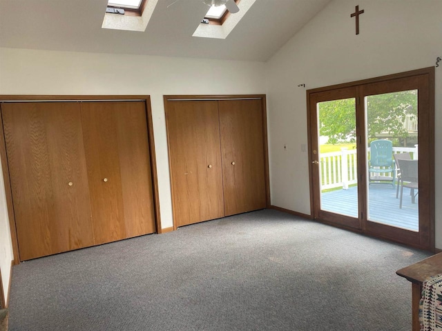352 N Harrison St, Lancaster, WI 53813 - unfurnished bedroom featuring a skylight, access to exterior, carpet floors, two closets, and high vaulted ceiling