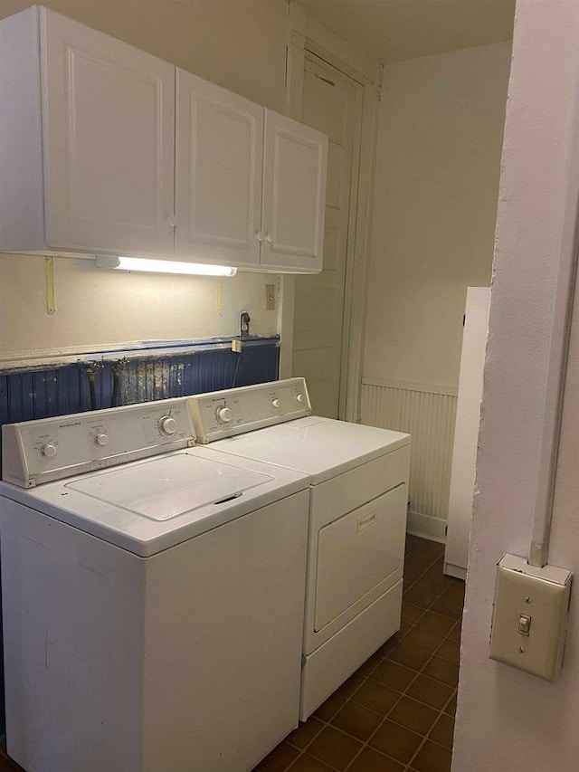 352 N Harrison St, Lancaster, WI 53813 - washroom featuring washing machine and dryer, dark tile patterned flooring, wainscoting, and cabinet space