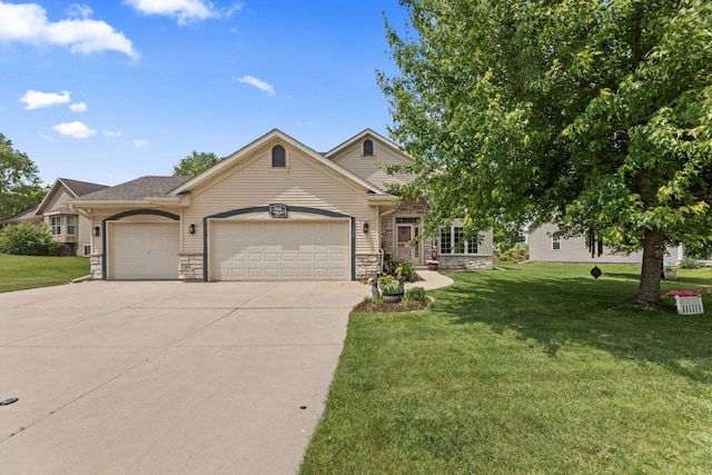104 Chapel Hill Dr, Johnson Creek, WI 53038 - view of front of property featuring stone siding, an attached garage, concrete driveway, and a front lawn