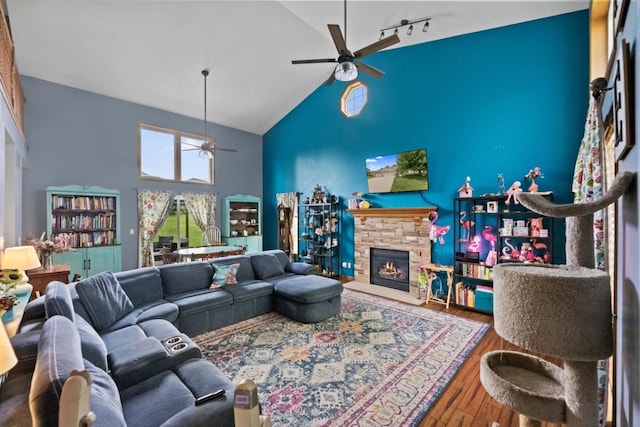 104 Chapel Hill Dr, Johnson Creek, WI 53038 - living area with high vaulted ceiling, a ceiling fan, wood finished floors, a fireplace, and track lighting