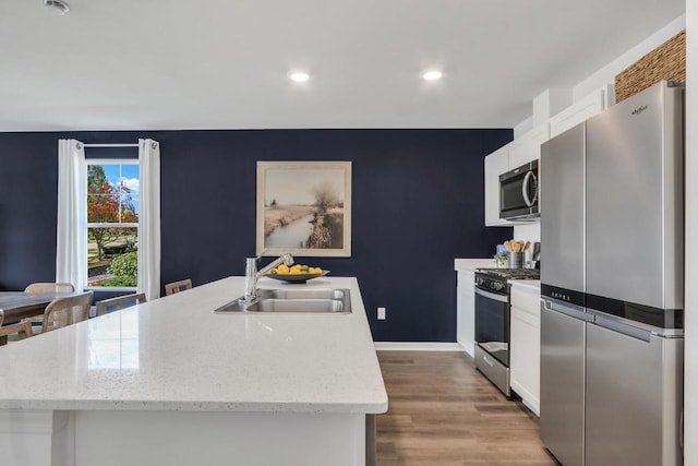 1062 58th Rd, Union Grove, WI 53182 - kitchen featuring appliances with stainless steel finishes, a sink, white cabinetry, light wood-style flooring, and recessed lighting