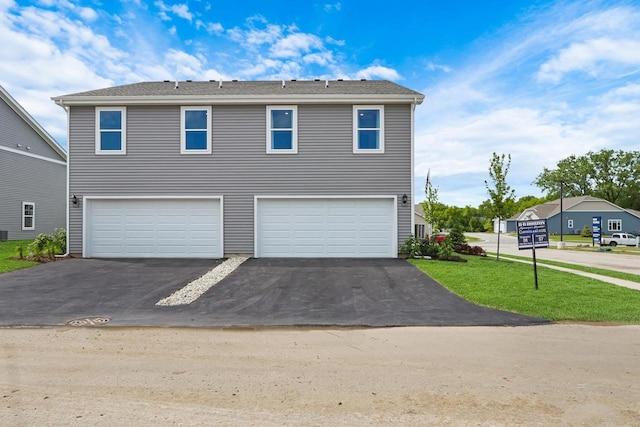 1062 58th Rd, Union Grove, WI 53182 - view of front of property featuring driveway, an attached garage, and a front lawn