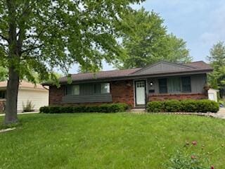 7062 N 46th St, Milwaukee, WI 53223 - ranch-style house with a front lawn and brick siding