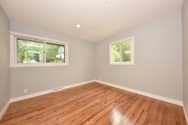 7062 N 46th St, Milwaukee, WI 53223 - spare room with wood finished floors and recessed lighting