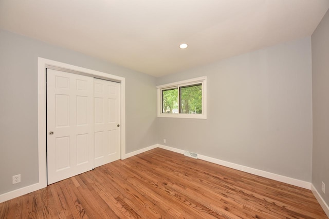 7062 N 46th St, Milwaukee, WI 53223 - unfurnished bedroom with light wood finished floors, a closet, and recessed lighting