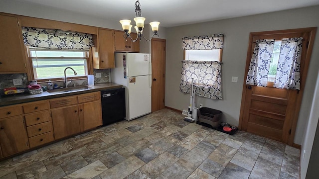 510 N Monroe St, Lancaster, WI 53813 - kitchen featuring black dishwasher, a sink, dark countertops, freestanding refrigerator, and healthy amount of natural light