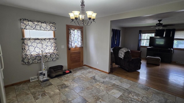 510 N Monroe St, Lancaster, WI 53813 - foyer entrance with a chandelier, baseboards, stone finish flooring, and ceiling fan