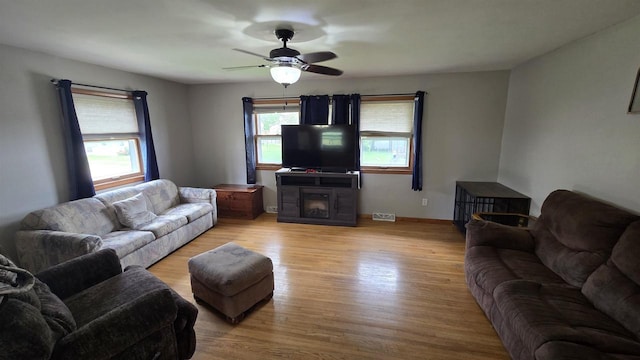 510 N Monroe St, Lancaster, WI 53813 - living area featuring light wood-style flooring, a ceiling fan, and a fireplace
