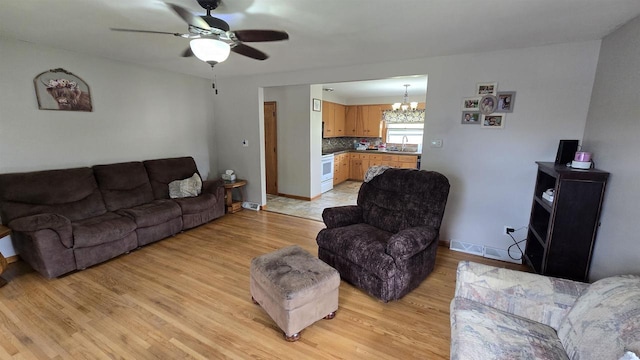 510 N Monroe St, Lancaster, WI 53813 - living area with a chandelier, ceiling fan, light wood-type flooring, and baseboards