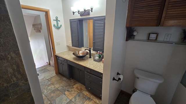 510 N Monroe St, Lancaster, WI 53813 - bathroom with vanity, toilet, and stone finish flooring