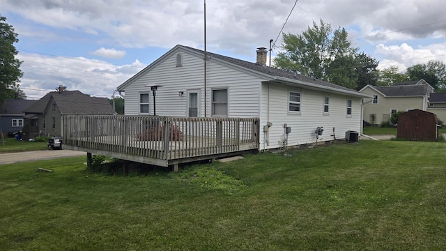 510 N Monroe St, Lancaster, WI 53813 - rear view of property with a chimney, a deck, a yard, and cooling unit